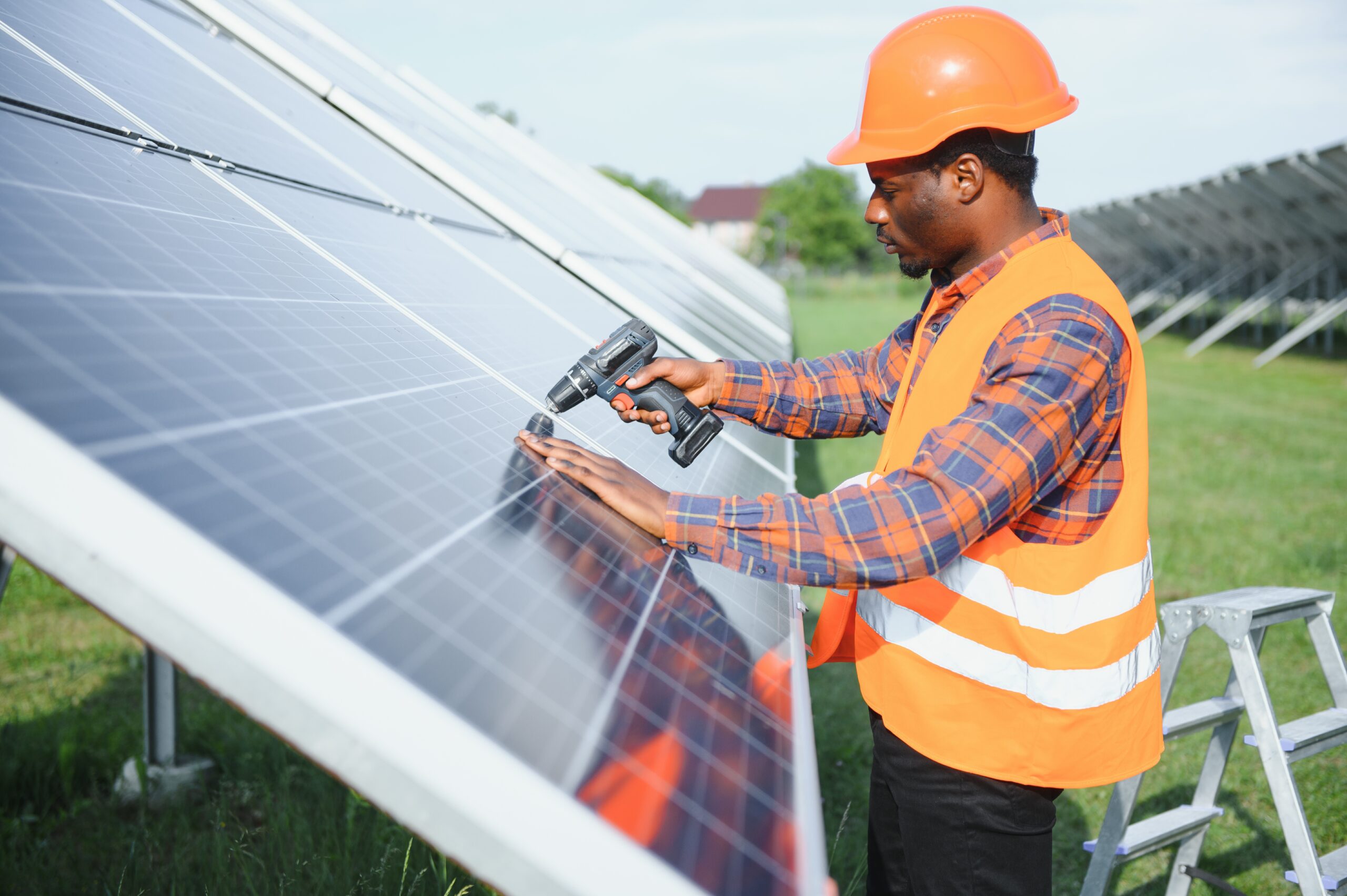 portrait african american electrician engineer safety helmet uniform installing solar panels scaled